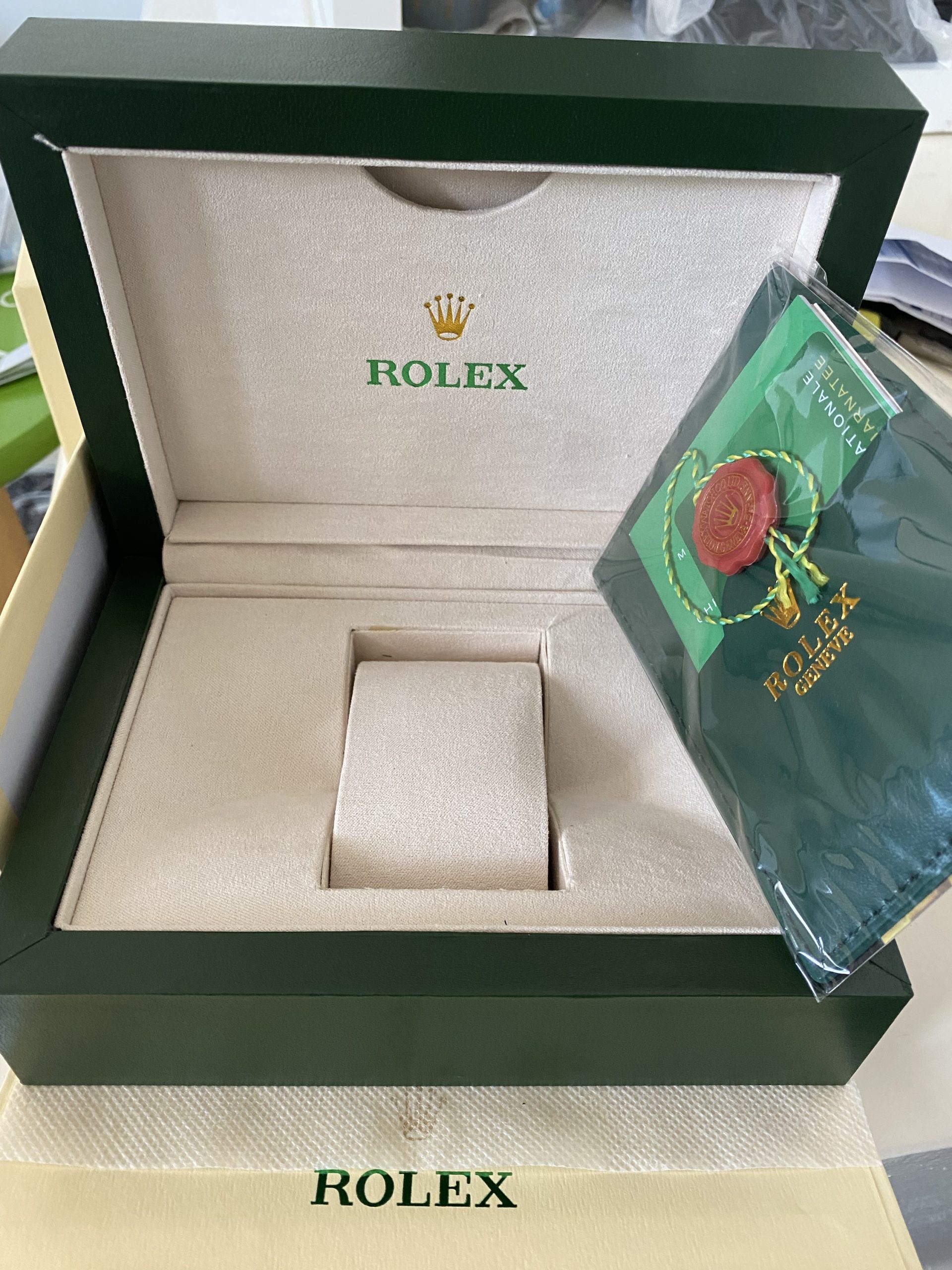 Rolex box and paper